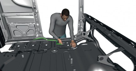 An operation where the manikin assembles a cable into the chassis (courtesy of Scania).